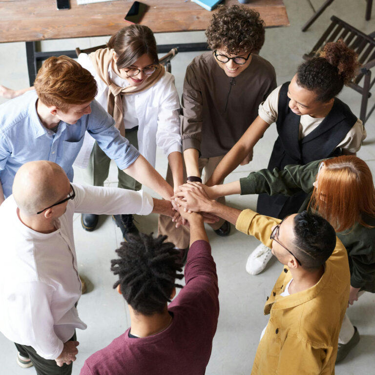 About the decidewise decision intelligence community community members placing hands in circle